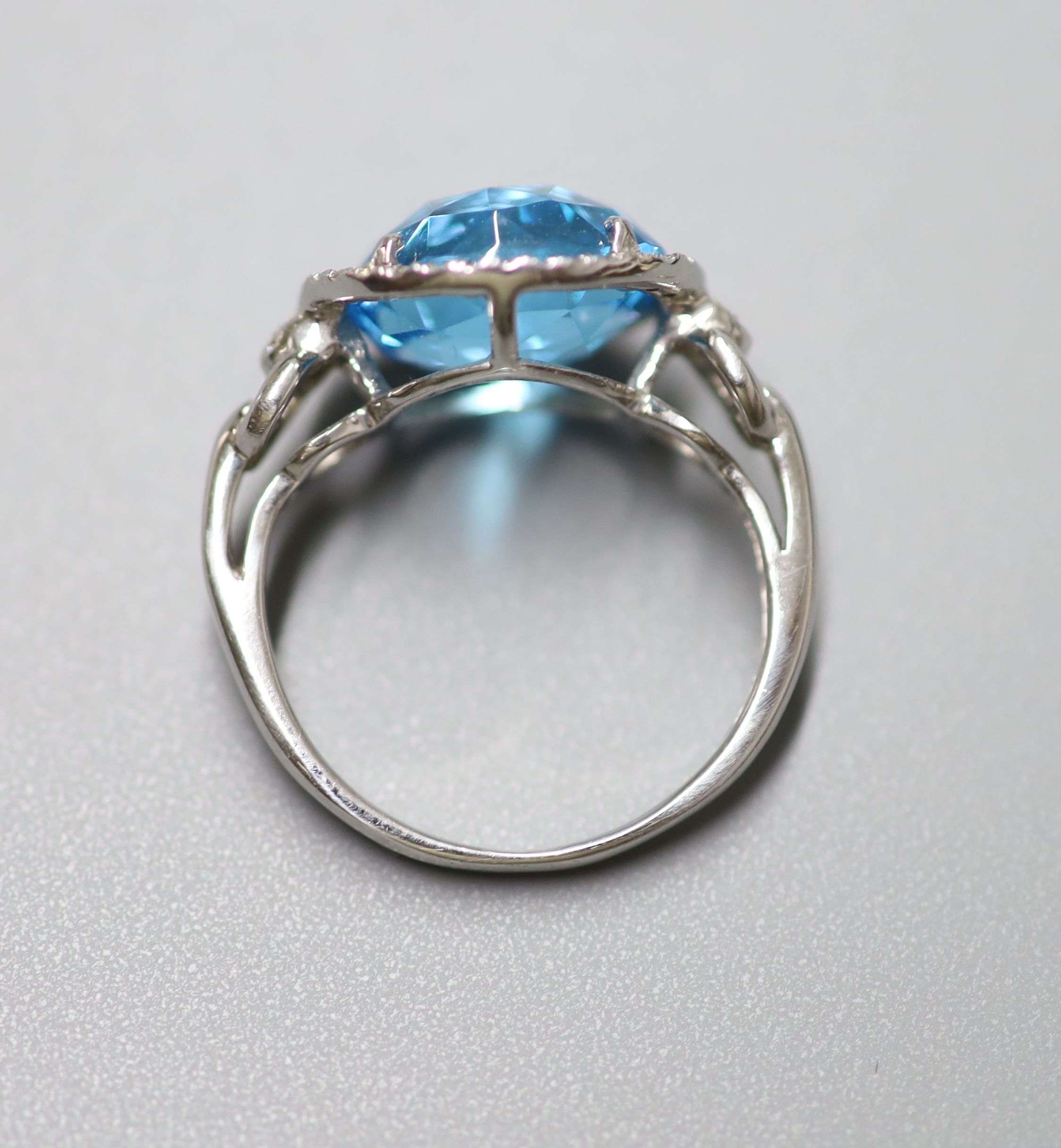 A modern 18ct white gold, blue topaz and diamond chip set dress ring, size L/M, gross 5 grams and a similar pair of drop earrings, stamped 375, gross 5 grams.